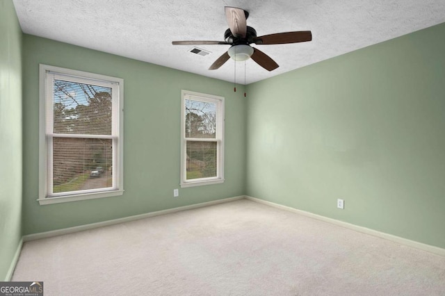 unfurnished room featuring ceiling fan, carpet flooring, and a textured ceiling