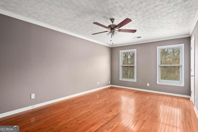 empty room featuring a textured ceiling, crown molding, ceiling fan, and light hardwood / wood-style floors