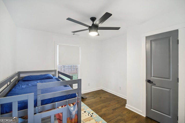 bedroom with ceiling fan and dark hardwood / wood-style floors