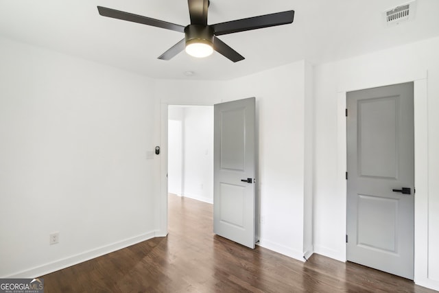 unfurnished bedroom with dark hardwood / wood-style flooring and ceiling fan