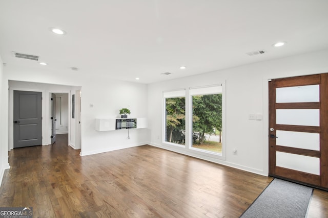 unfurnished living room featuring dark hardwood / wood-style flooring