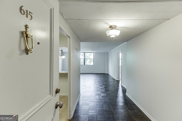 hallway featuring a textured ceiling