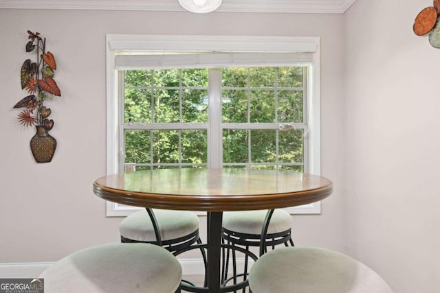 dining area featuring crown molding