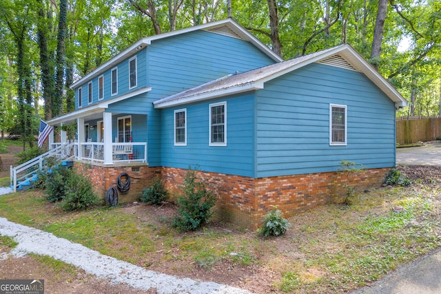 view of side of property with a porch