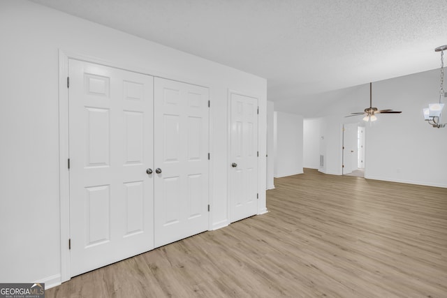 interior space featuring ceiling fan, a textured ceiling, and light hardwood / wood-style floors