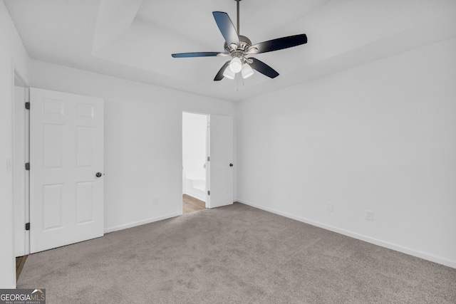 spare room featuring light colored carpet and ceiling fan