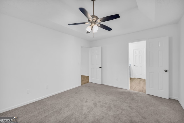 unfurnished bedroom with light colored carpet and ceiling fan