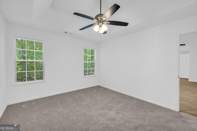 carpeted spare room with ceiling fan