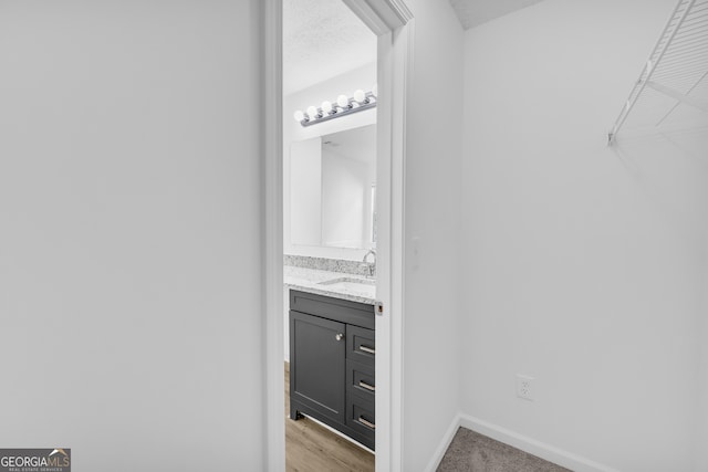 interior space with vanity and a textured ceiling