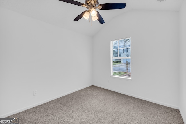 carpeted spare room with ceiling fan and lofted ceiling