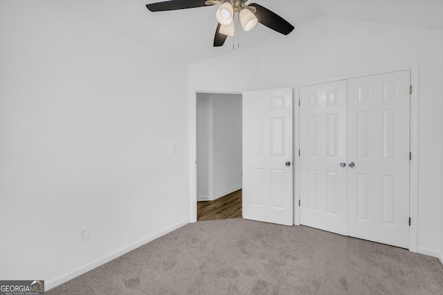 unfurnished bedroom with carpet floors, vaulted ceiling, a closet, and ceiling fan