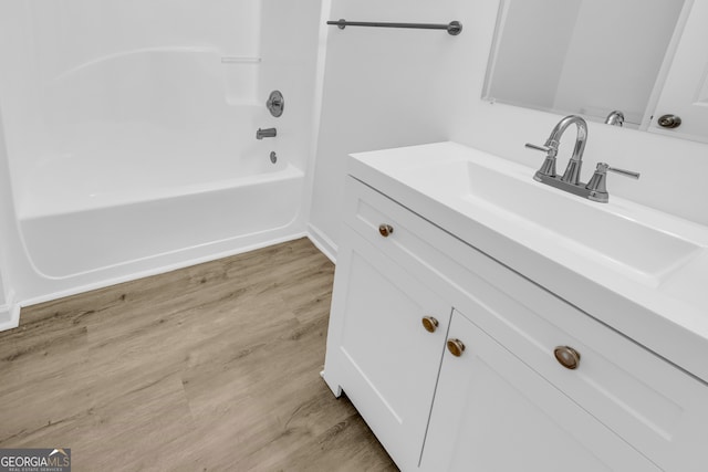 bathroom featuring vanity, hardwood / wood-style flooring, and shower / bath combination