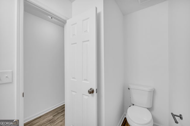 bathroom featuring hardwood / wood-style floors and toilet