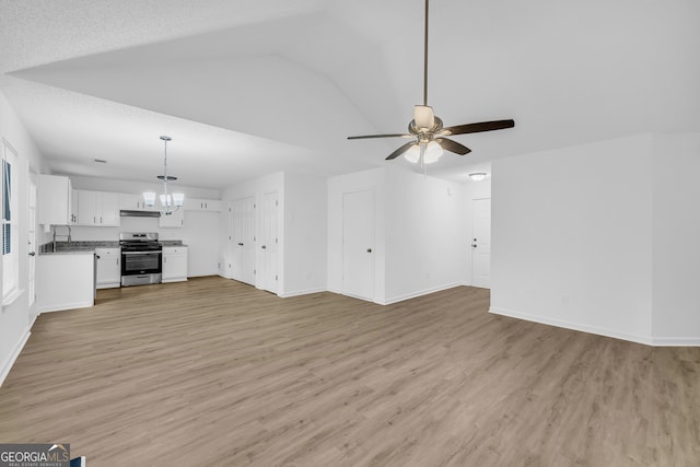 unfurnished living room featuring lofted ceiling, sink, ceiling fan with notable chandelier, and light wood-type flooring