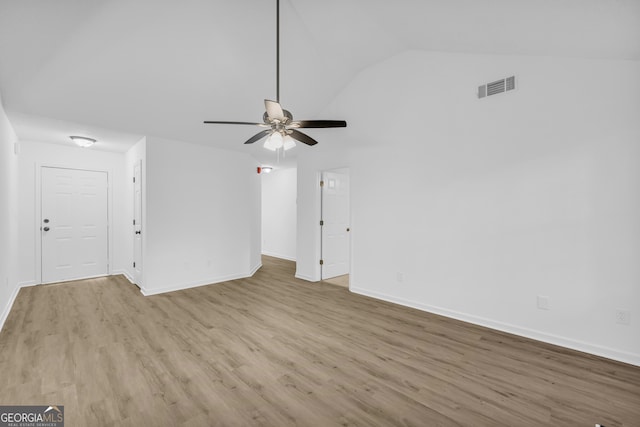 spare room featuring lofted ceiling, light hardwood / wood-style flooring, and ceiling fan