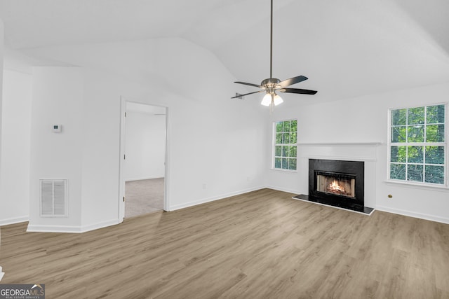 unfurnished living room featuring lofted ceiling, ceiling fan, and light wood-type flooring