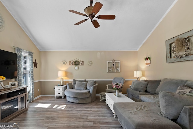 living room with lofted ceiling, ornamental molding, and wood finished floors