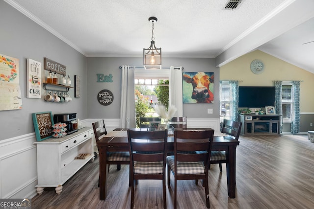 dining room with crown molding, vaulted ceiling, dark hardwood / wood-style flooring, and a textured ceiling