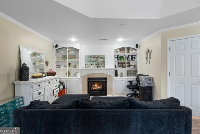 bedroom featuring ornamental molding, ceiling fan, wood-type flooring, and a raised ceiling