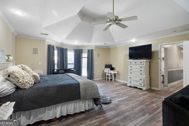 bedroom with ceiling fan, wood finished floors, visible vents, baseboards, and crown molding