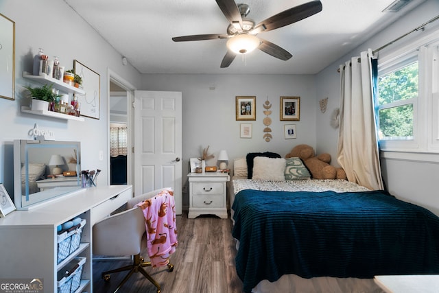 bedroom with ceiling fan and dark hardwood / wood-style floors