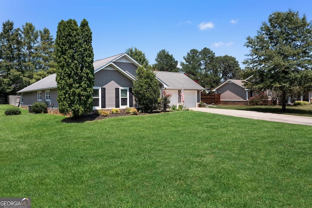 single story home featuring a front lawn, a garage, and driveway