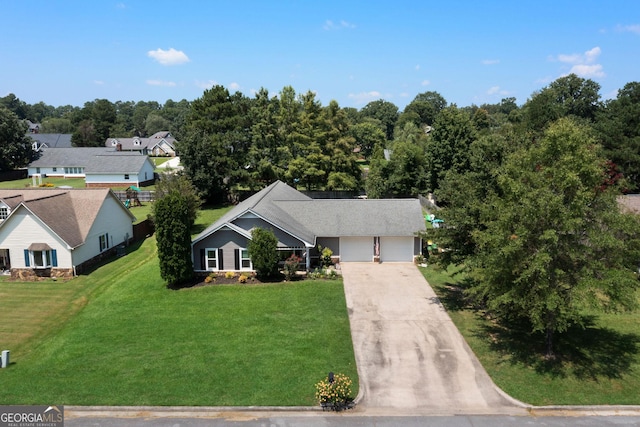 view of front of home with driveway, a garage, and a front yard