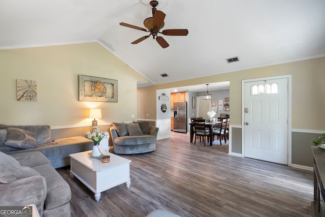 living room featuring ceiling fan, vaulted ceiling, ornamental molding, and dark hardwood / wood-style flooring