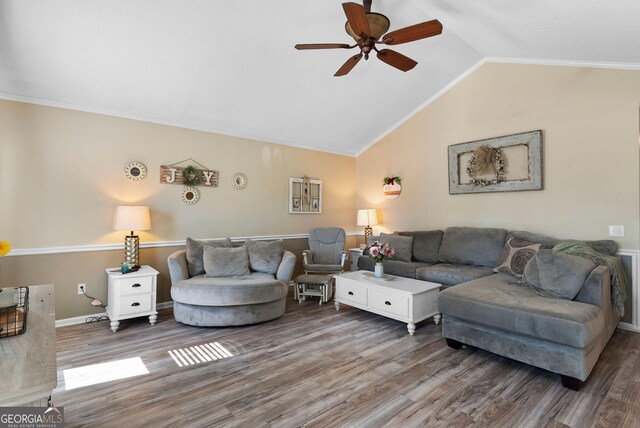 living room with lofted ceiling, crown molding, and wood finished floors