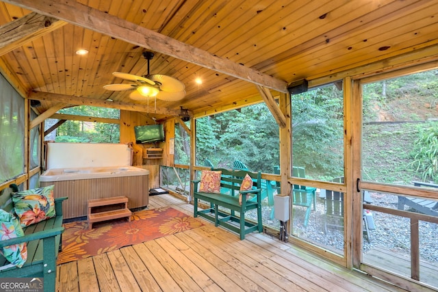 sunroom / solarium with a hot tub, beamed ceiling, ceiling fan, and wood ceiling