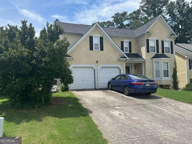 view of front of house featuring a garage and a front yard