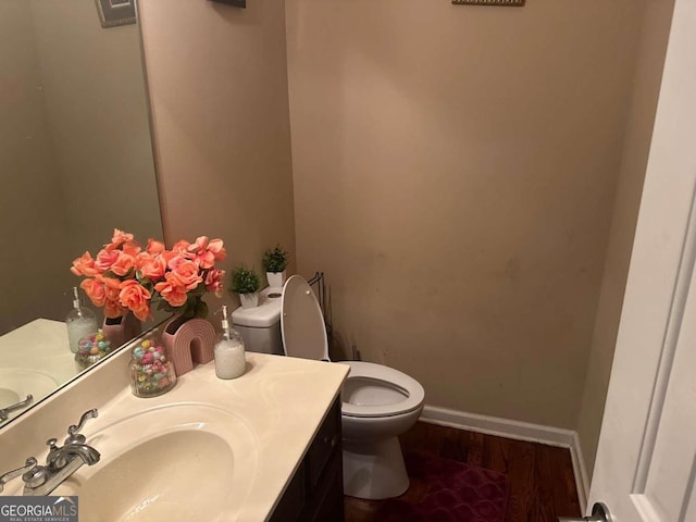 bathroom with vanity, hardwood / wood-style floors, and toilet