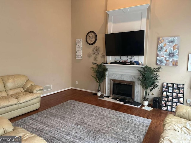 living room with a fireplace and dark hardwood / wood-style floors