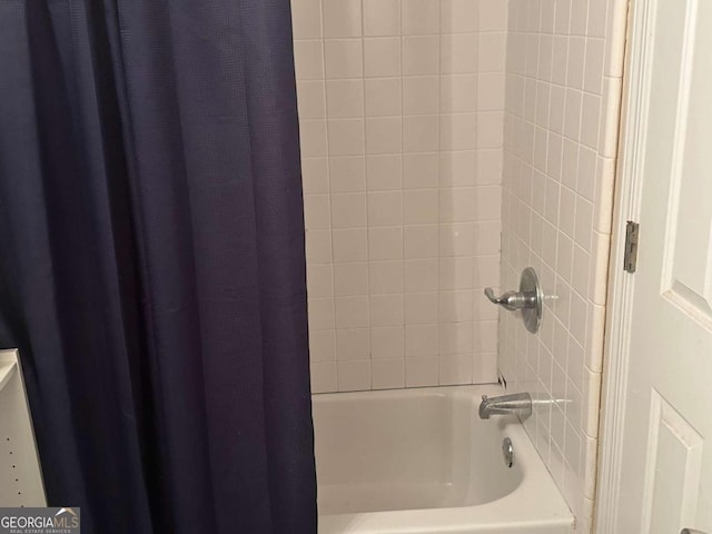 bathroom with shower / bath combo with shower curtain