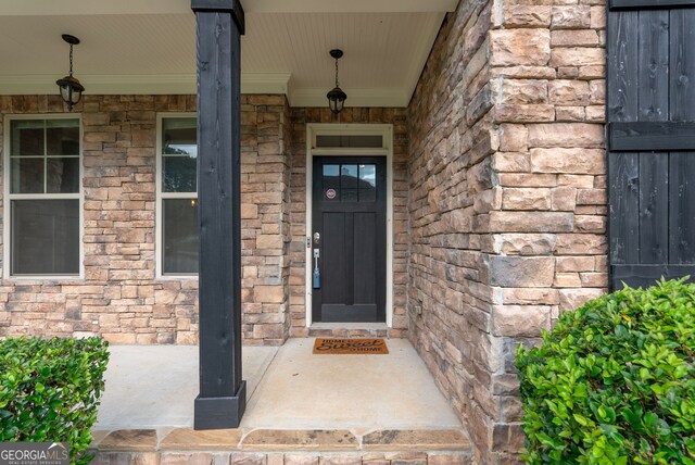 doorway to property featuring covered porch