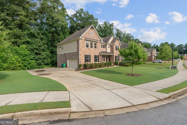 view of front of house with a front lawn and a garage