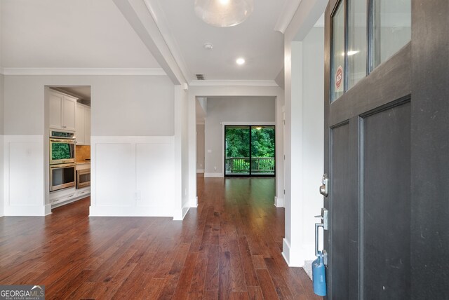 foyer featuring dark hardwood / wood-style flooring and ornamental molding