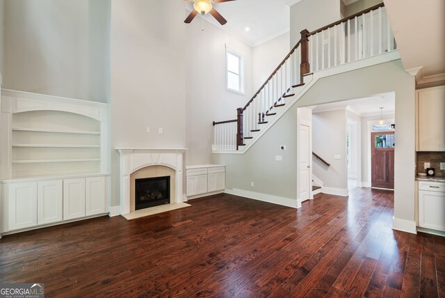 unfurnished living room featuring ceiling fan, a wealth of natural light, and hardwood / wood-style flooring