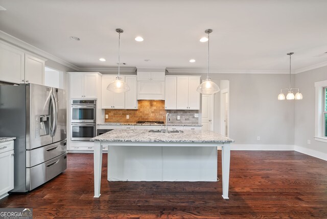 kitchen with dark wood-type flooring, stainless steel appliances, backsplash, and decorative light fixtures