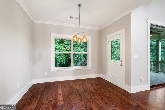 unfurnished dining area featuring ceiling fan with notable chandelier, ornamental molding, and dark wood-type flooring