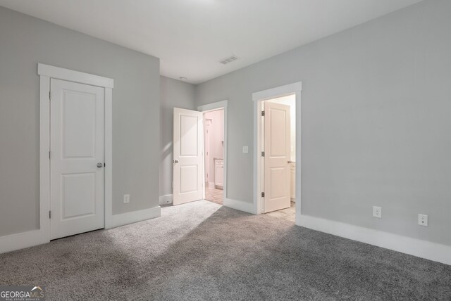 unfurnished bedroom with light carpet