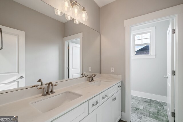 bathroom featuring dual bowl vanity and tile patterned flooring