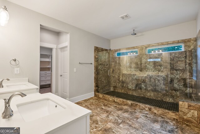 bathroom with dual vanity, tile patterned floors, and a shower with door