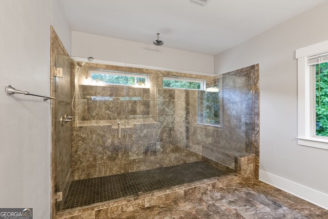 bathroom with tile patterned floors, a shower with door, and plenty of natural light