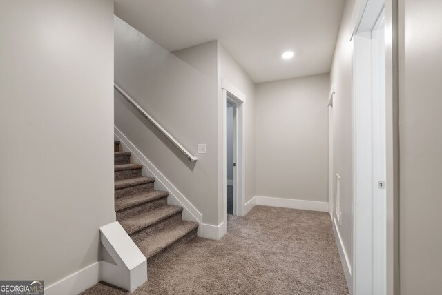 staircase with light colored carpet