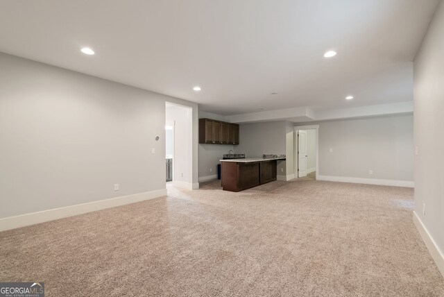 unfurnished living room with light colored carpet