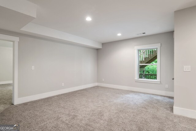 unfurnished room with light colored carpet