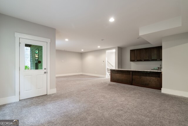 unfurnished living room with light colored carpet