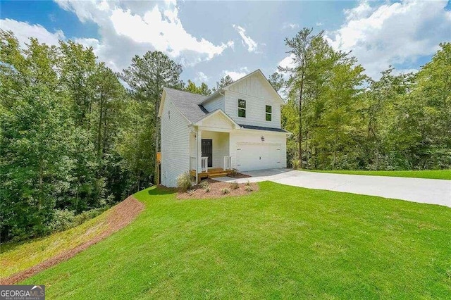 rear view of house featuring a lawn and a garage