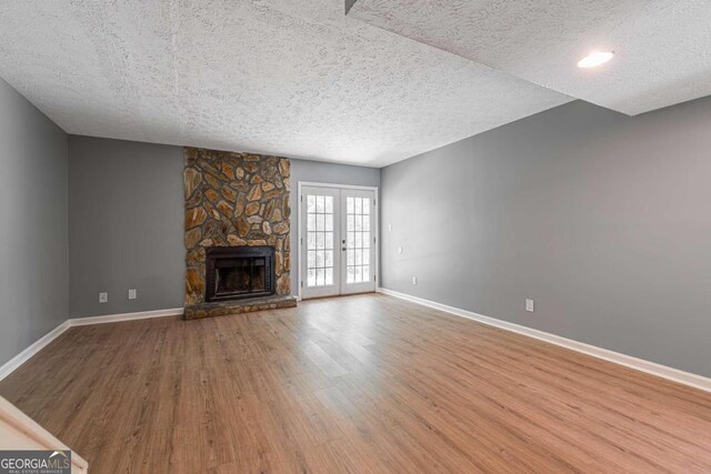 2498 Hidden Cove Ct Unit D, Gainesville, GA 30501 - unfurnished living room featuring a textured ceiling, stairs, and light wood-style floors